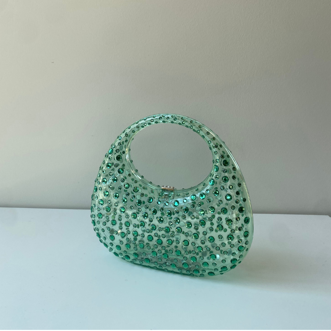 A sculptural mini made to shine. Top handle = your new favorite plus-one.