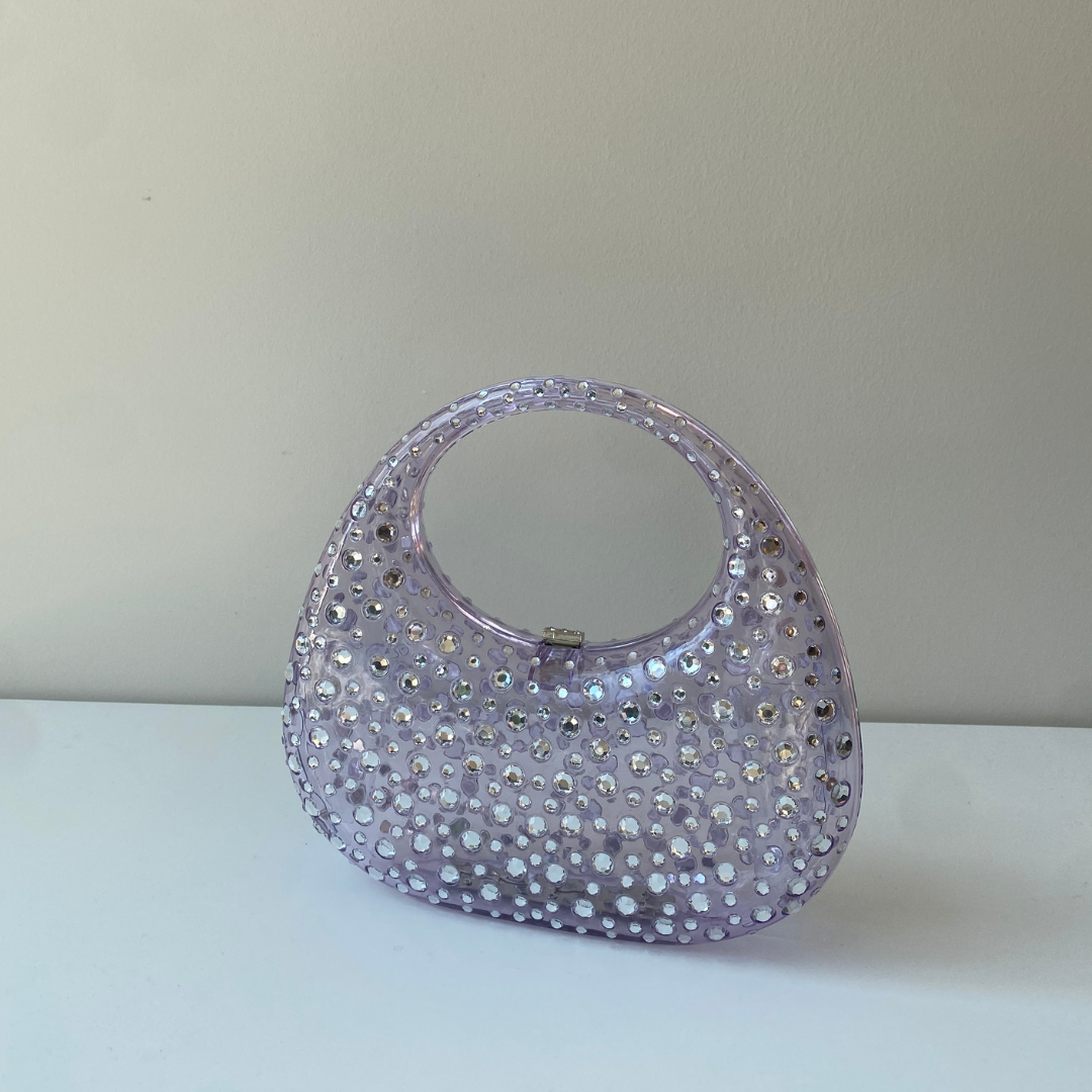 A sculptural mini made to shine. Top handle + crossbody chain = your new favorite plus-one.