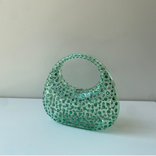 A sculptural mini made to shine. Top handle = your new favorite plus-one.
