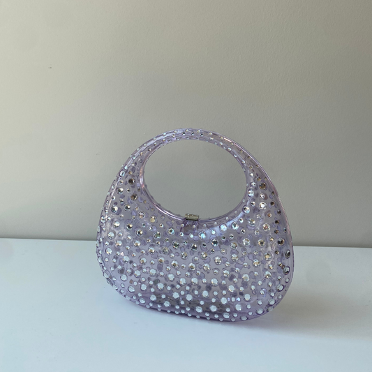 A sculptural mini made to shine. Top handle + crossbody chain = your new favorite plus-one.